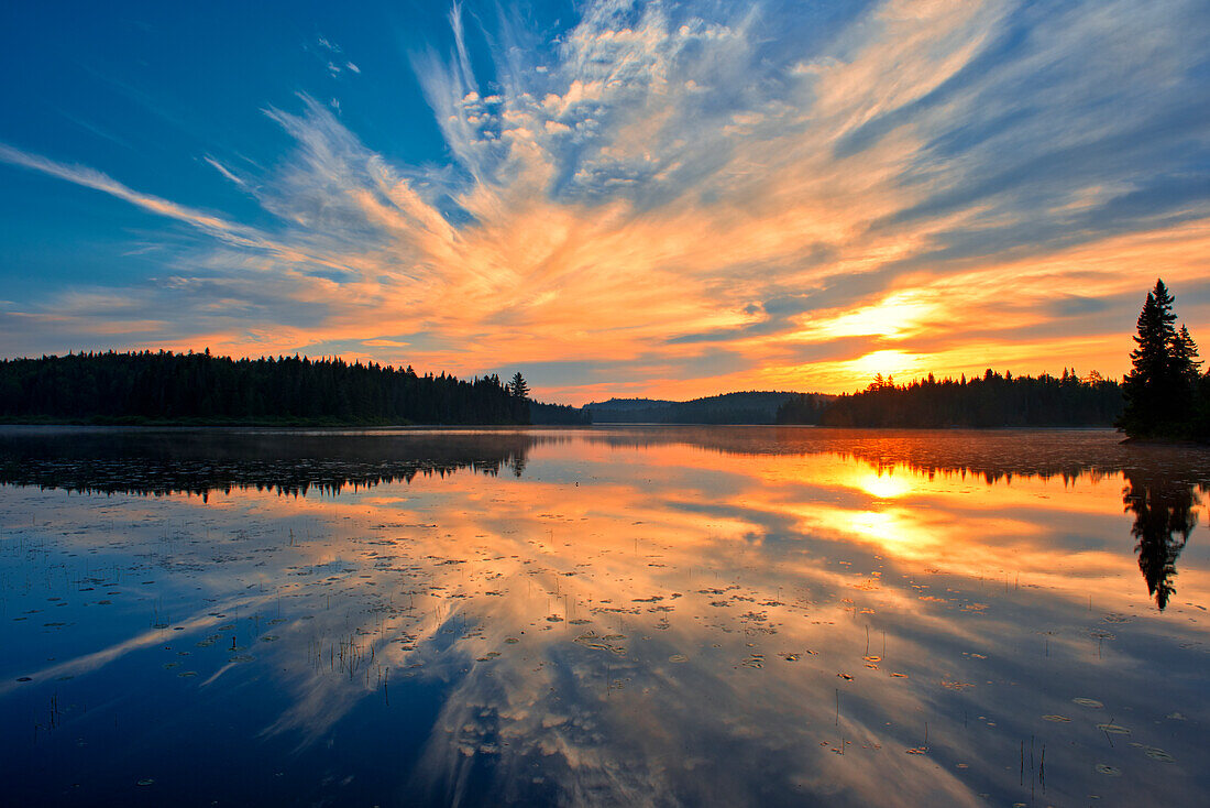 Canada, Quebec, La Mauricie National Park. Reflection of clouds in Lac du Fou at sunrise