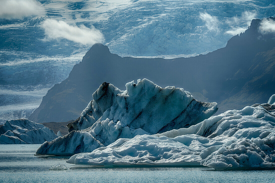 Iceland, floating glaciers in Jokulsarlon, glacier lagoon with mountain echo.