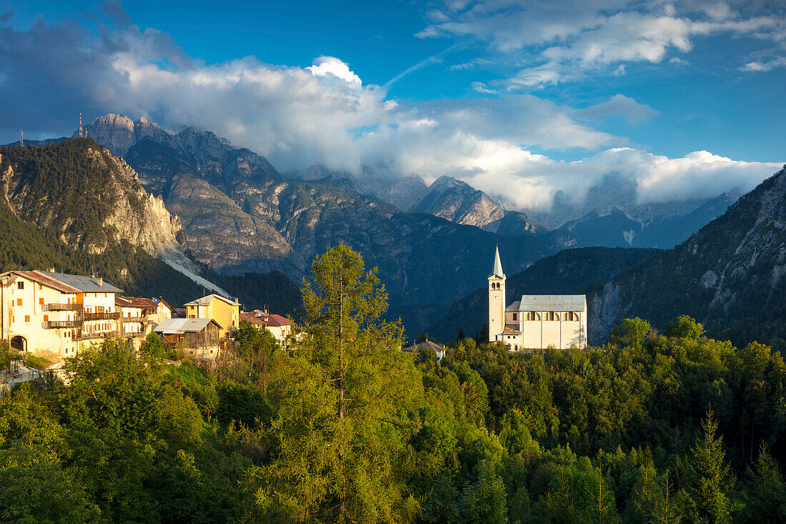 Evening sunlight over Chiesa di San Martino and the Dolomite Mountains near Venas di Cadore, Veneto, Italy