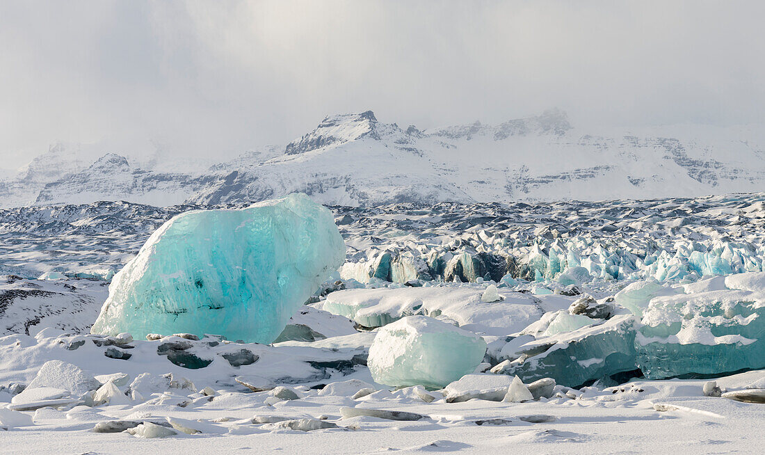 Northern shore of glacial lagoon Jokulsarlon with glacier Breidamerkurjokull in Vatnajokull National Park. Northern Europe, Iceland.