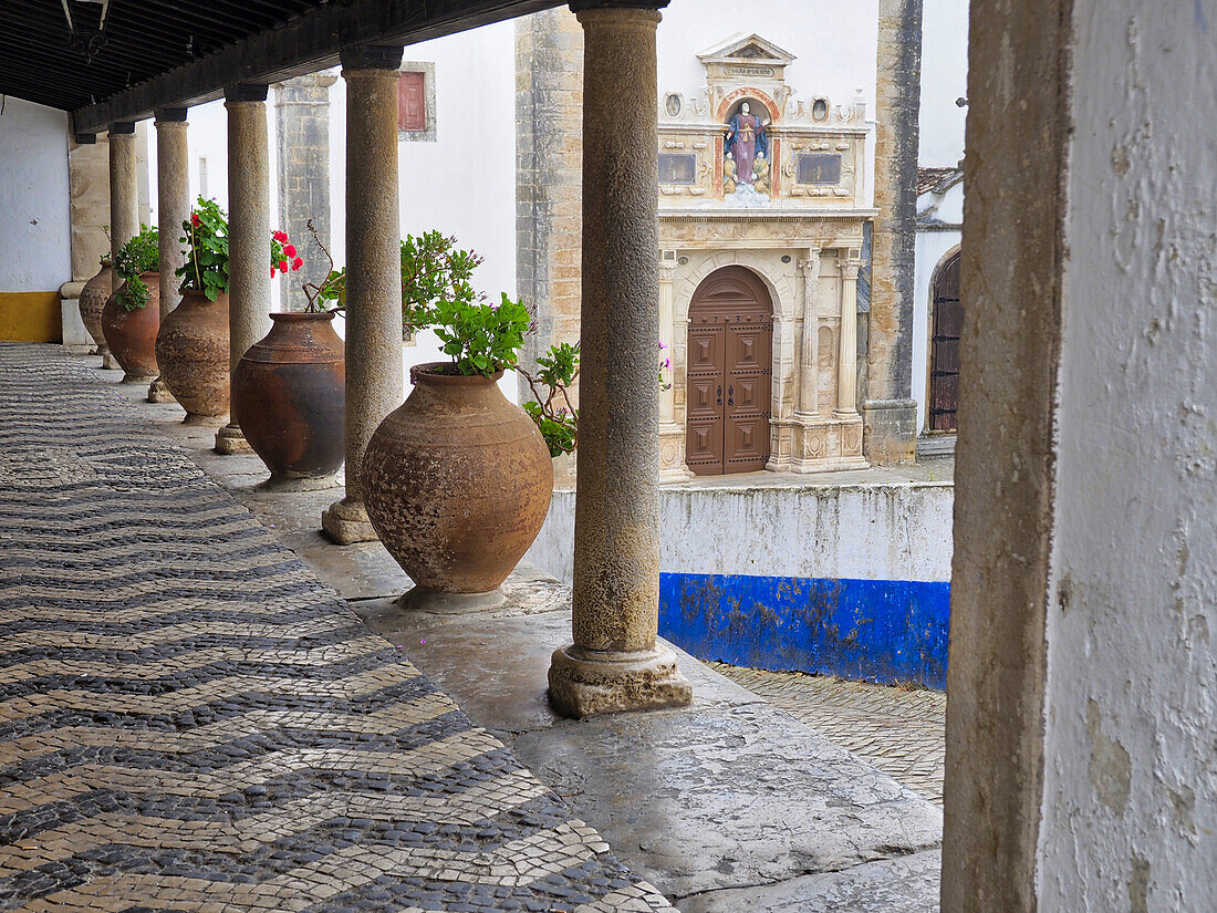 Portugal, Obidos. Ceramic pots adorning a building ledge.
