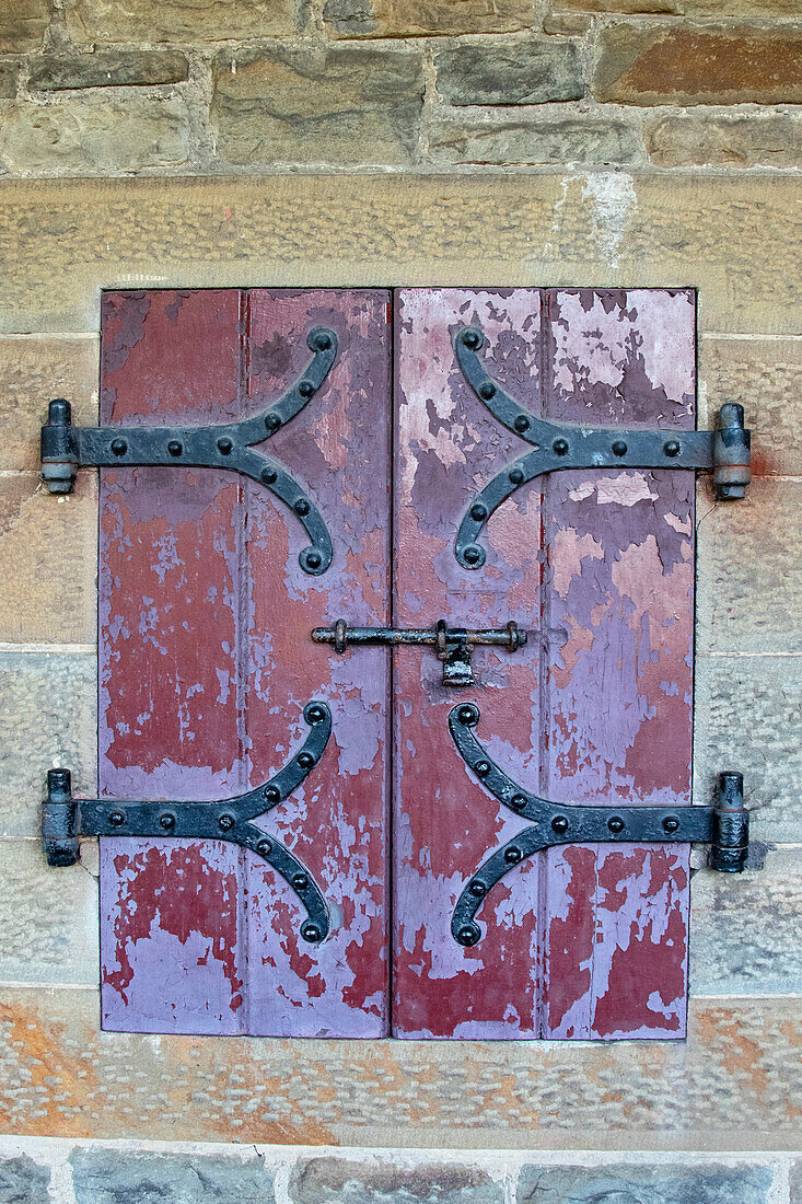 Türen mit schmiedeeisernen Scharnieren befinden sich in einem Durchgang im Cardiff Castle, Wales.