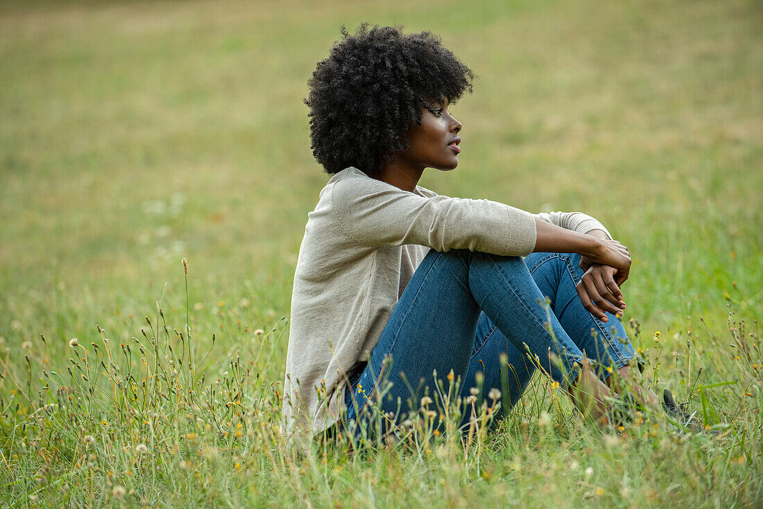 Thoughtful young woman sitting in park