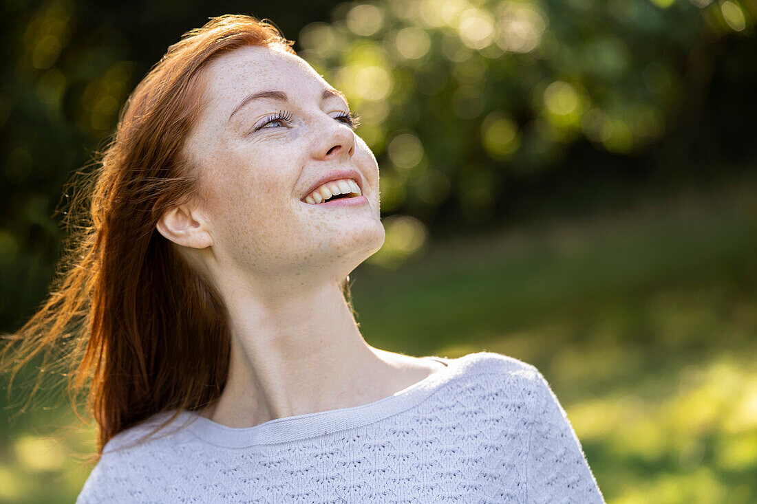 Close-up of smiling young woman in park