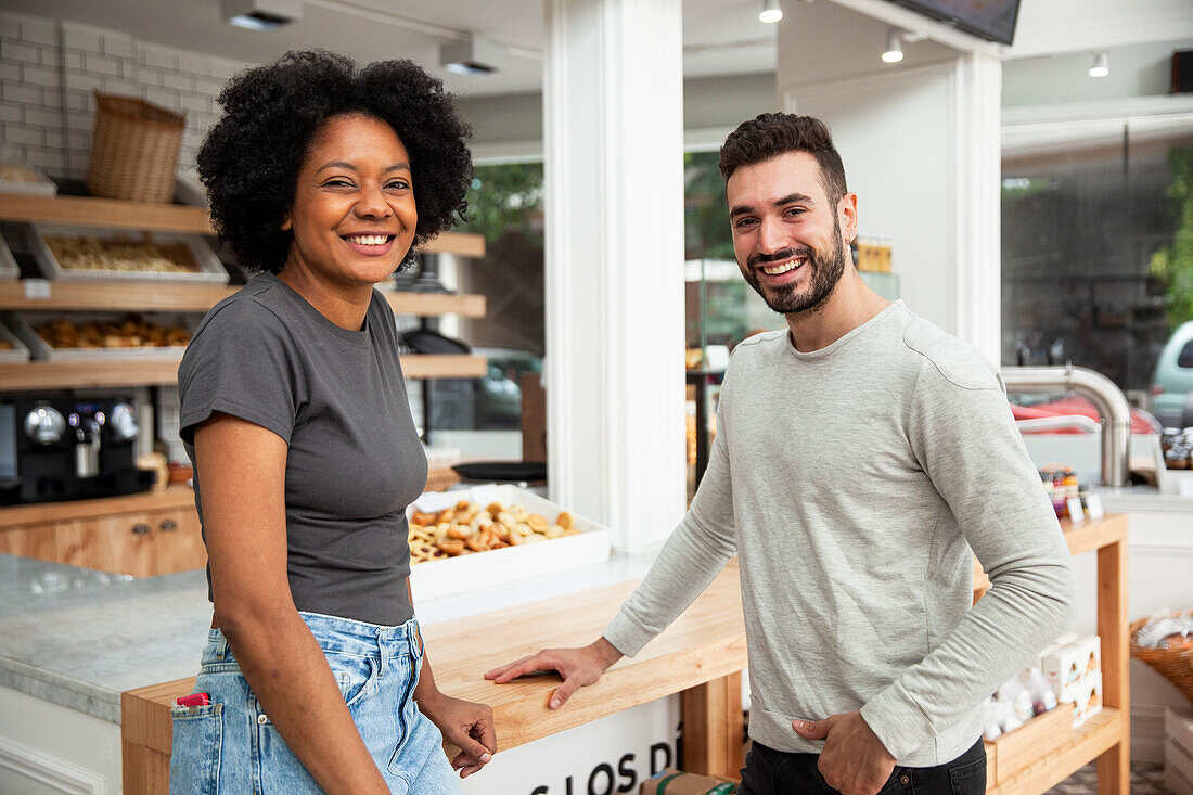 Female and male entrepreneur looking at the camera