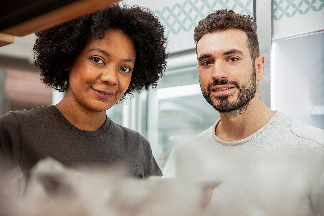 Bakery coworkers standing in bakery looking at the camera