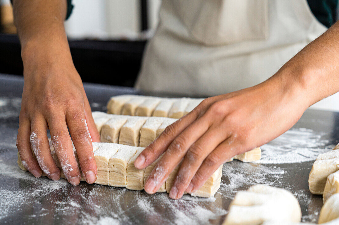 Close-up shot of female baker's hands making pastry