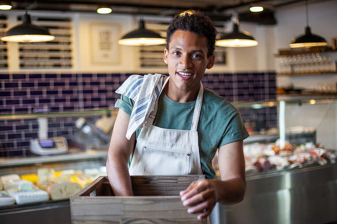 Young Latin American man working in grocery store