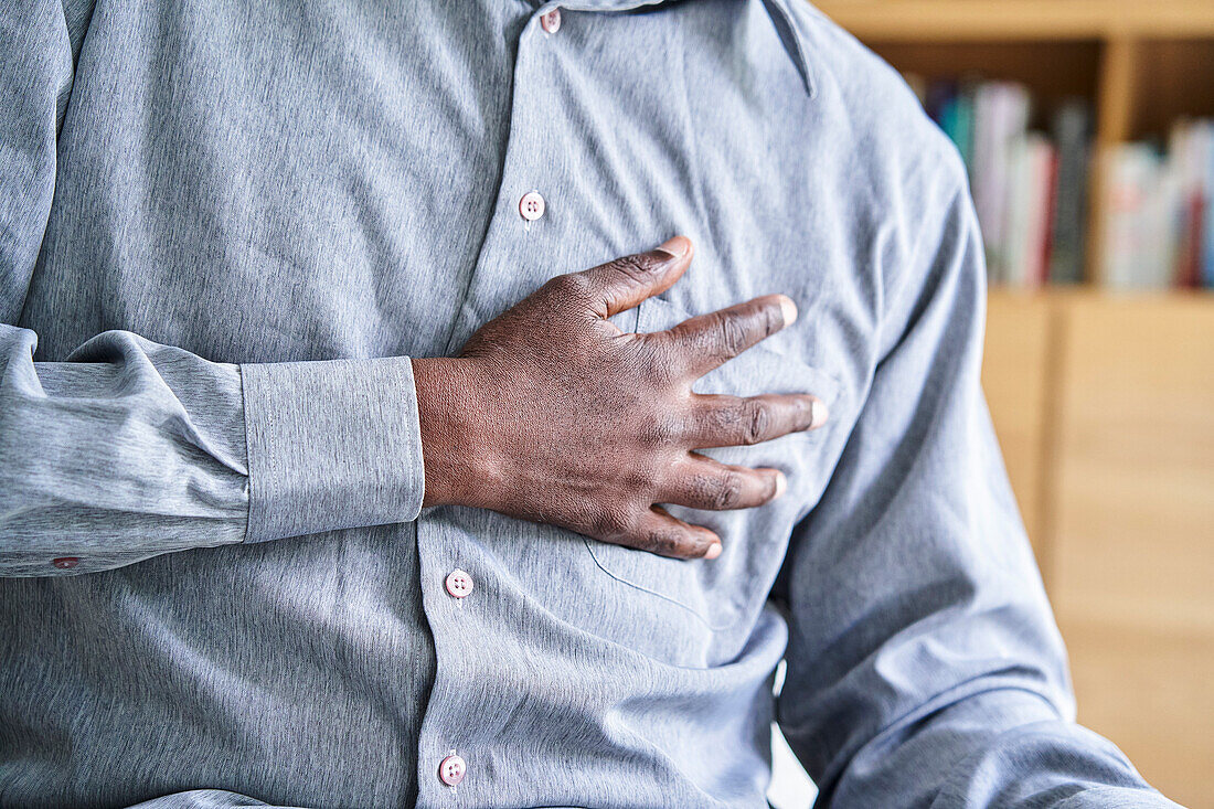 Close-up shot of African-American man with hand on chest