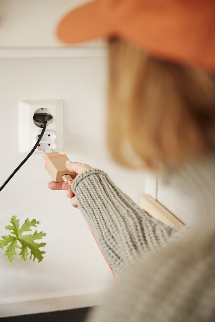 Woman plugging in charger