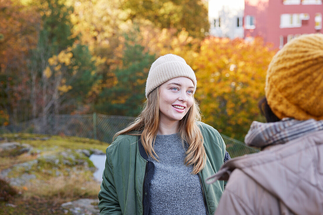 Women talking in autumn scenery