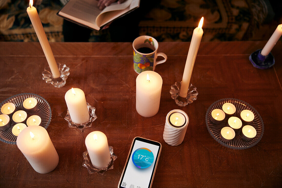 Candles and phone with temperature app
