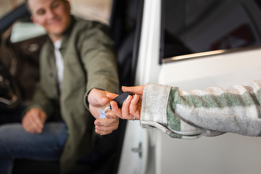 Customers trying car in car dealership office