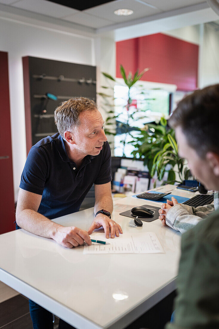 Customers in car dealership office