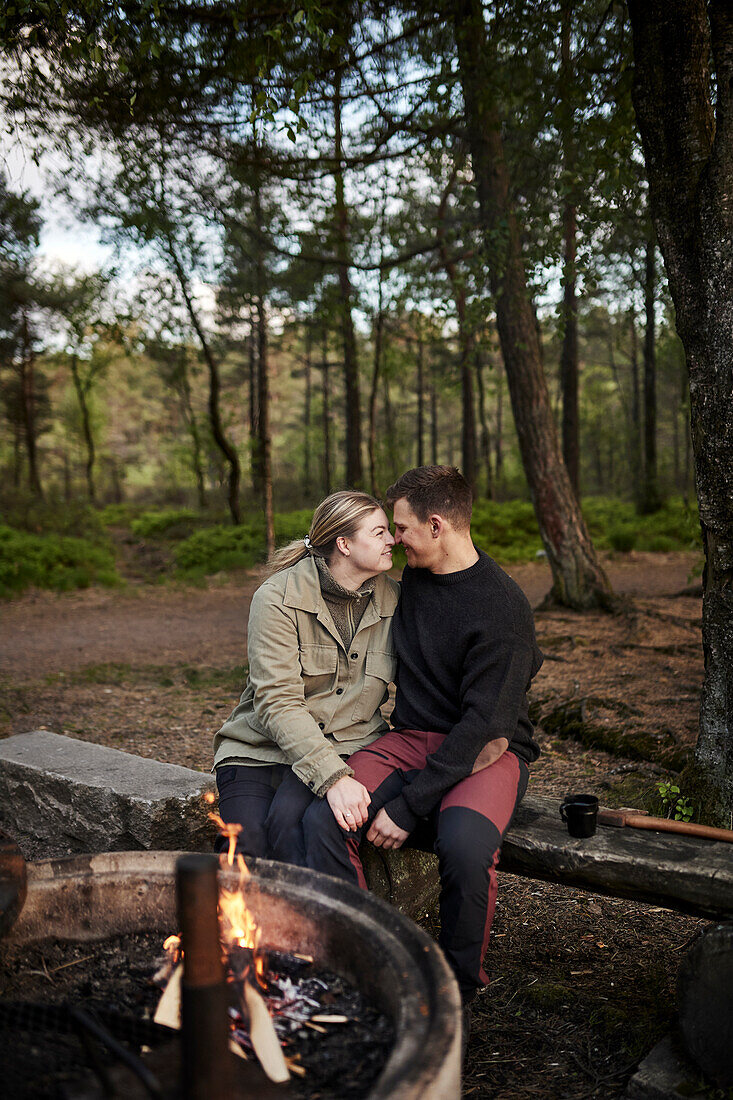 Pärchen sitzt am Lagerfeuer