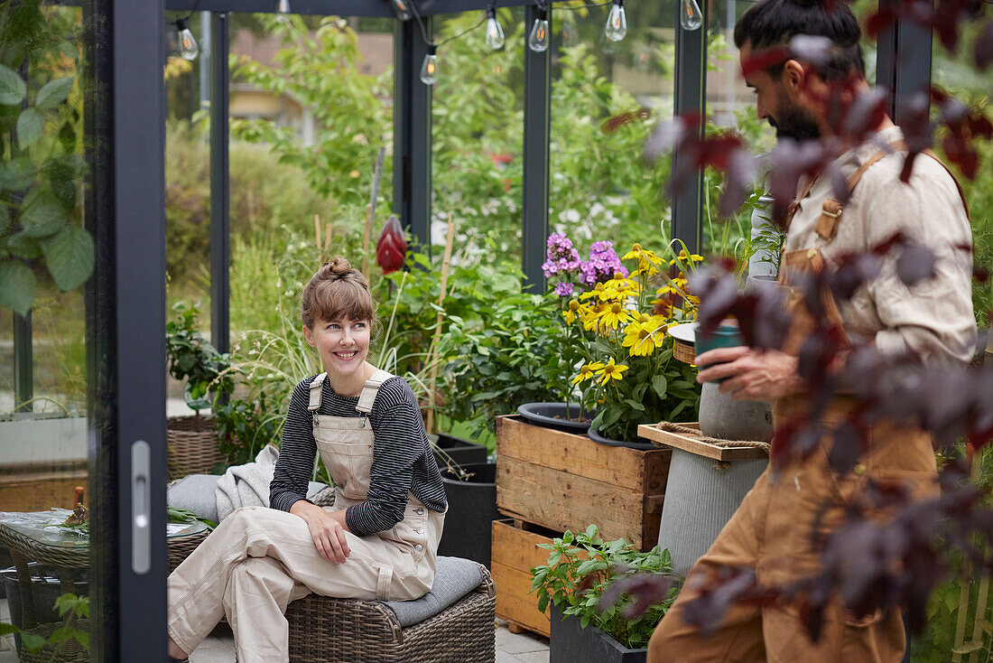 Friends talking in greenhouse