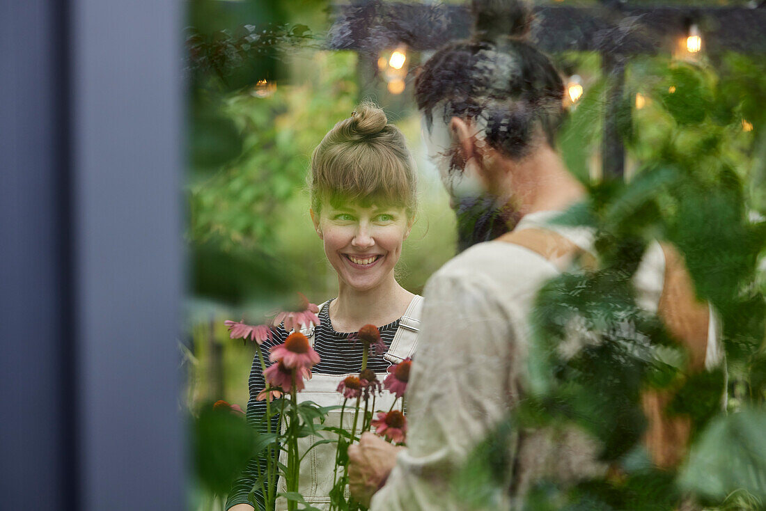 Smiling woman in greenhouse