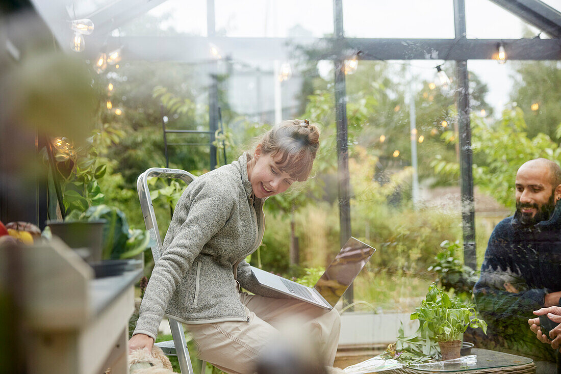 Smiling woman in greenhouse