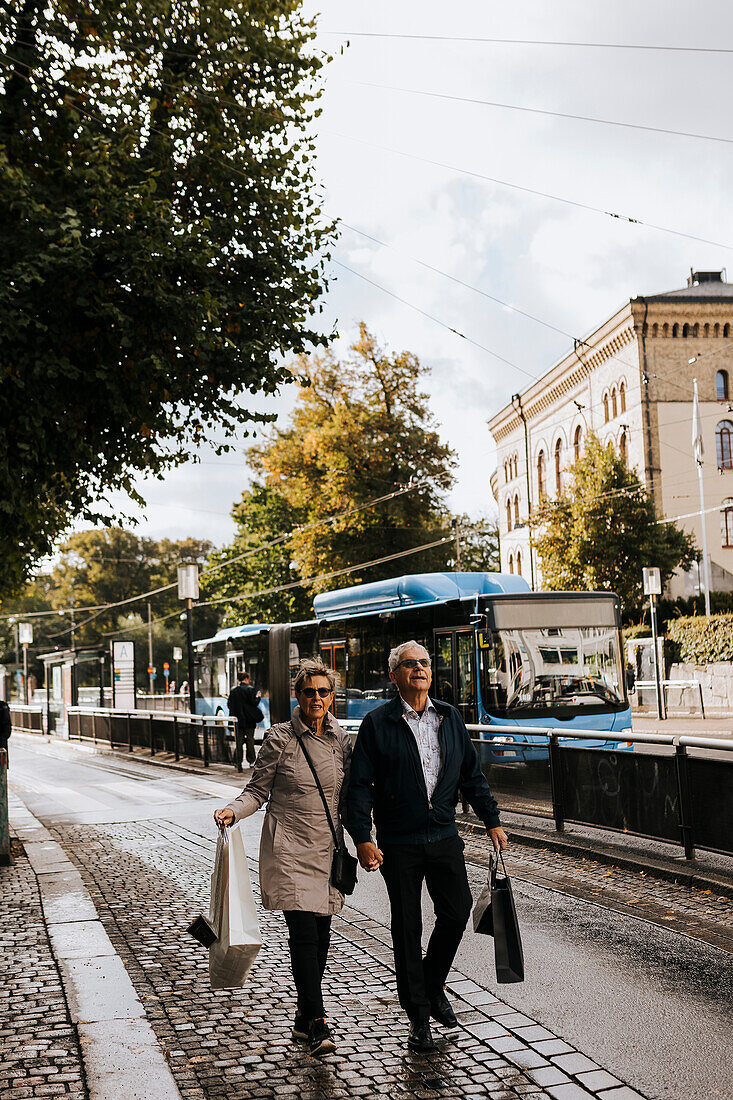 Couple walking in city with shopping bags