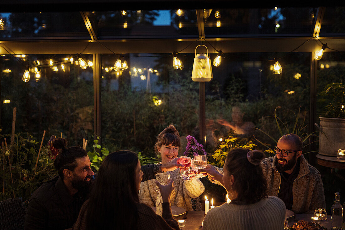 Friends having meal in greenhouse