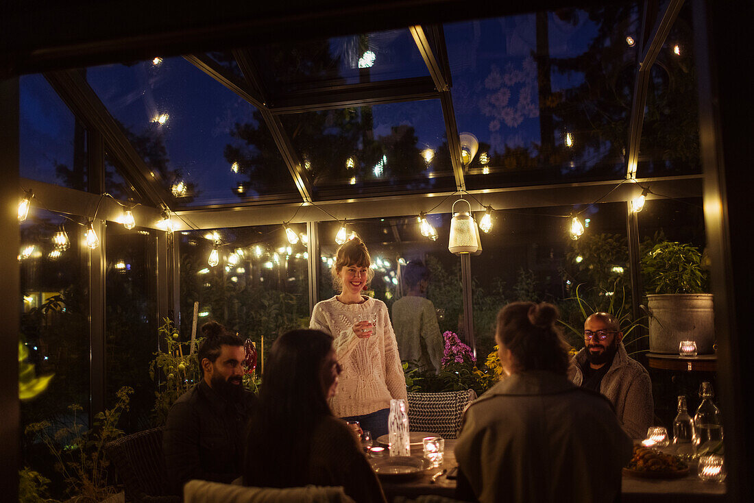 Friends having meal in greenhouse