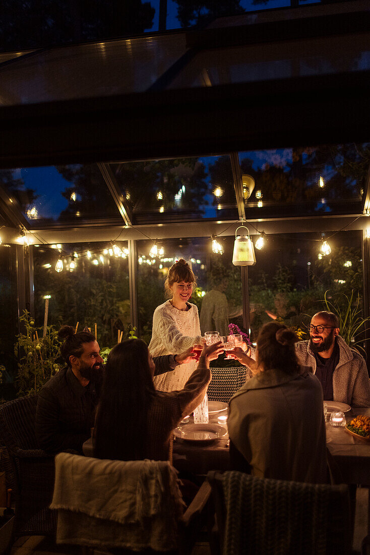 Friends having meal in greenhouse