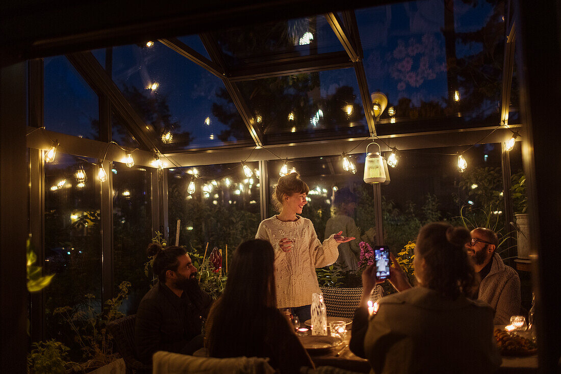 Friends having meal in greenhouse