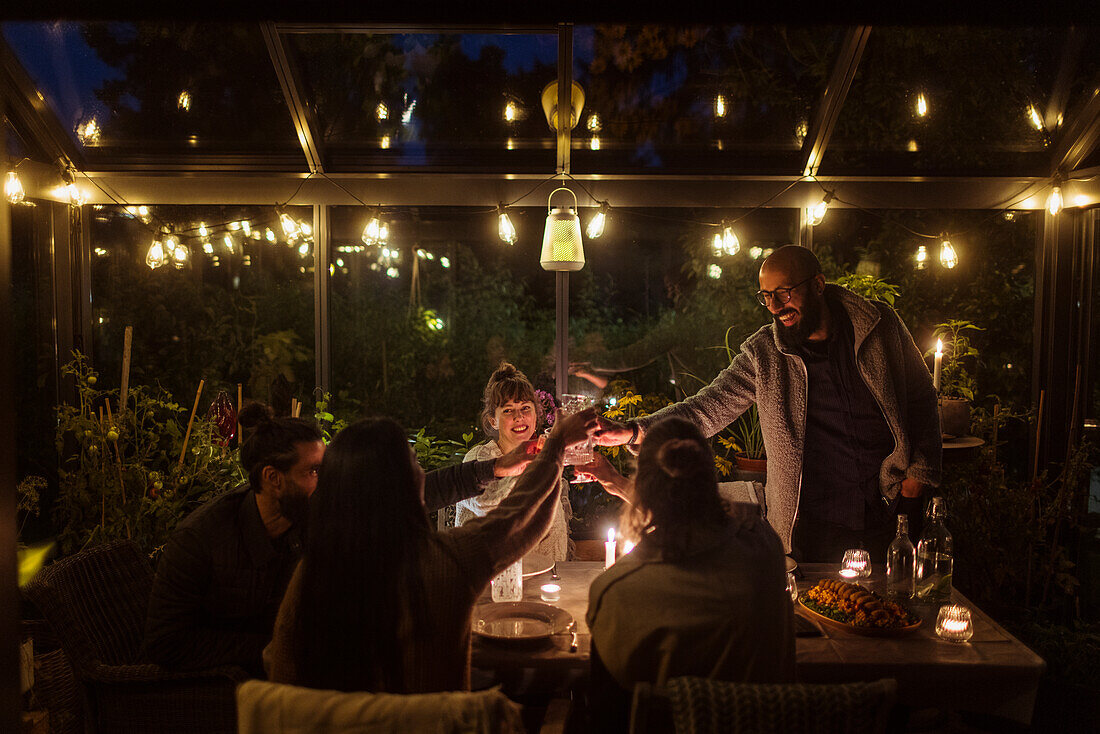 Friends having meal in greenhouse