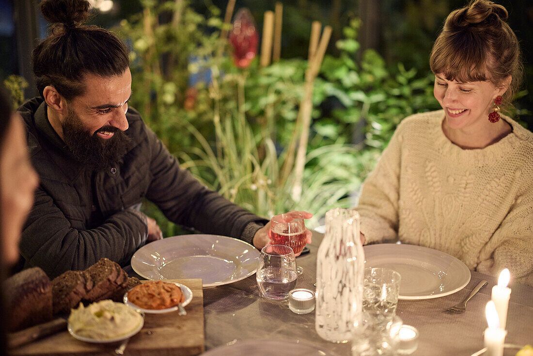 Happy friends having evening meal together