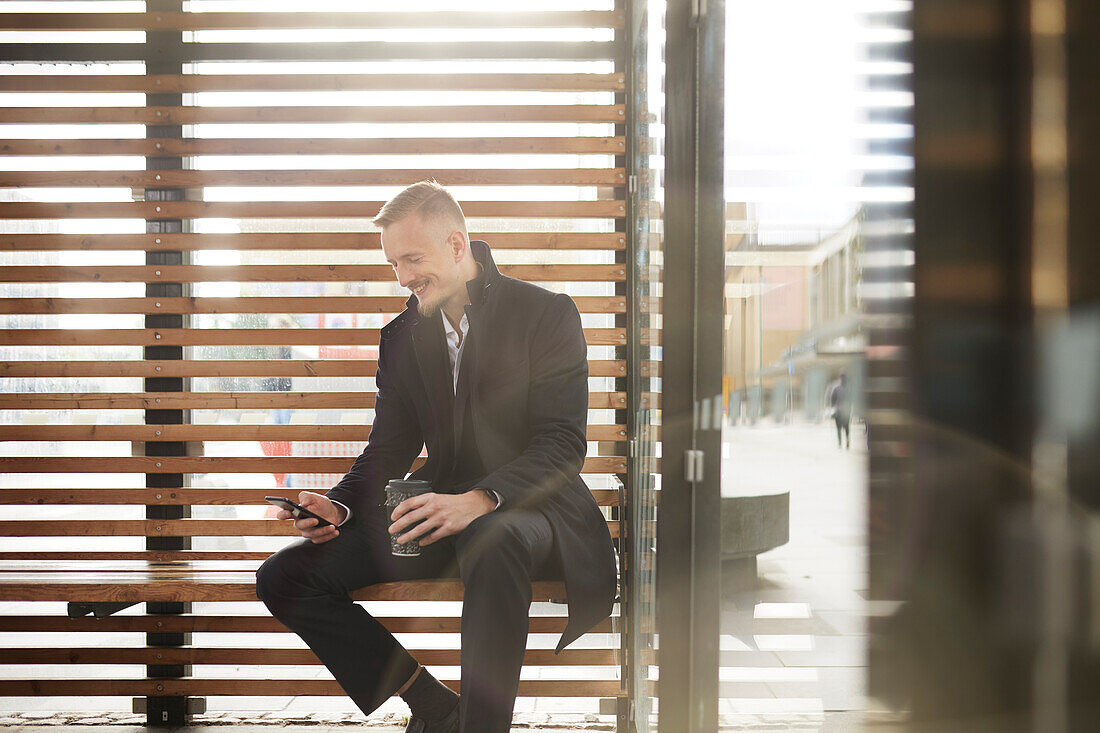 Smiling businessman using cell phone