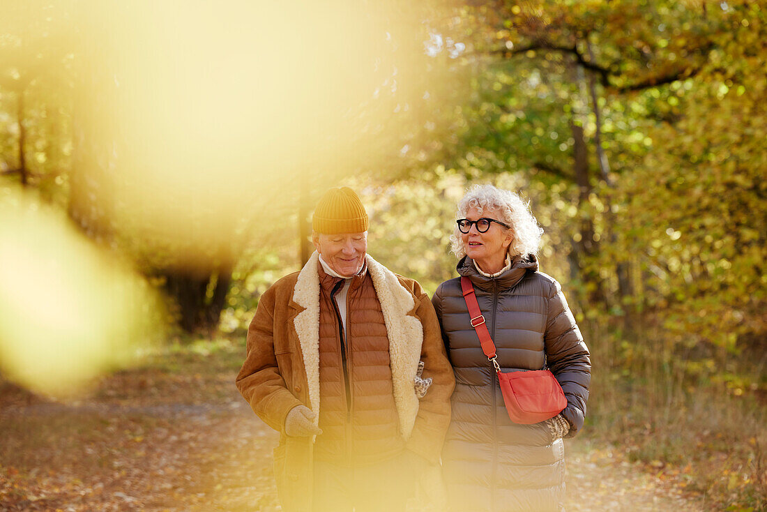 Senior couple walking in autumn park