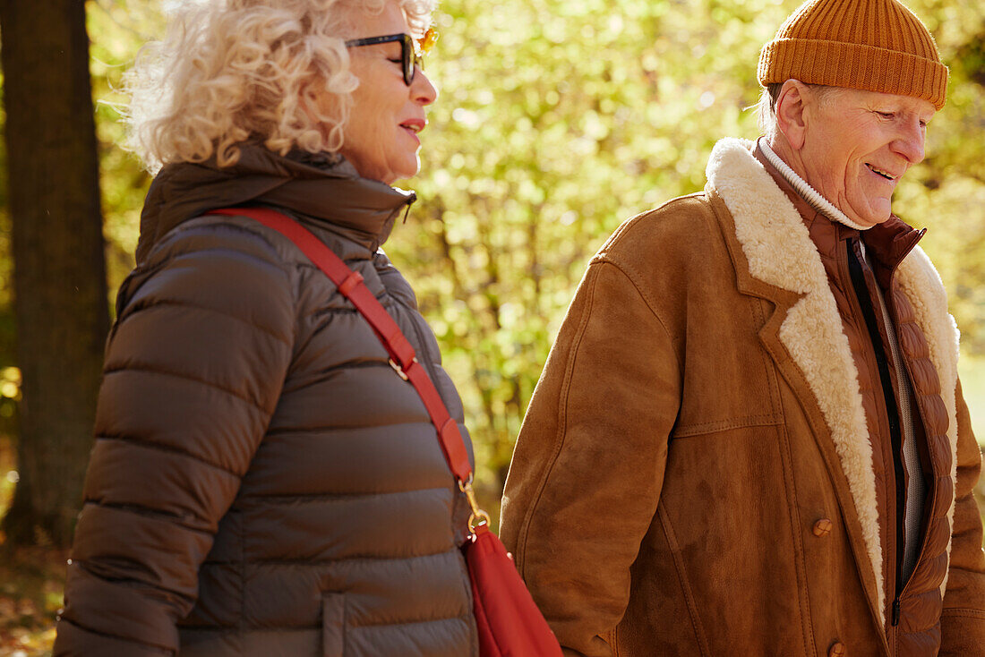 Senior couple walking in autumn park