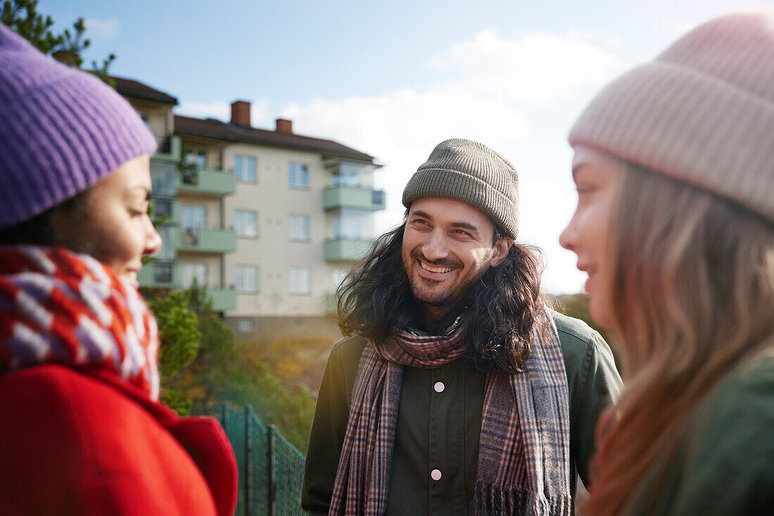 Smiling friends talking together