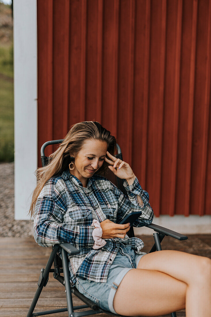 Smiling woman using cell phone