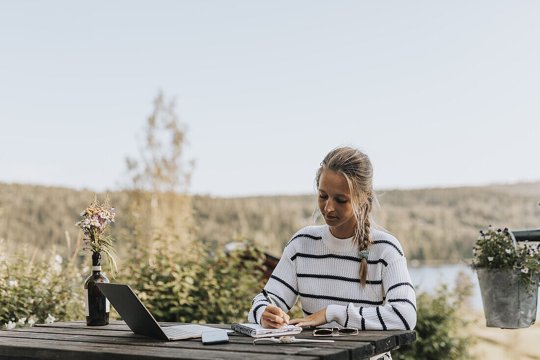 Young woman taking notes