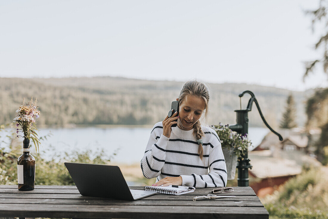 Young woman taking via cell phone