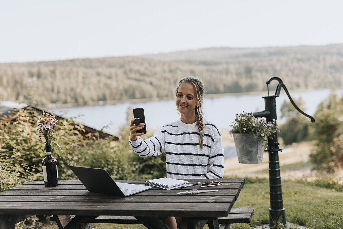 Smiling woman taking selfie