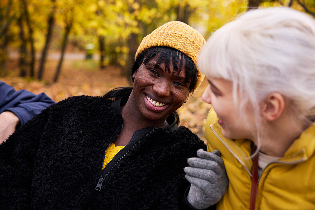 Two friends in park in autumn scenery