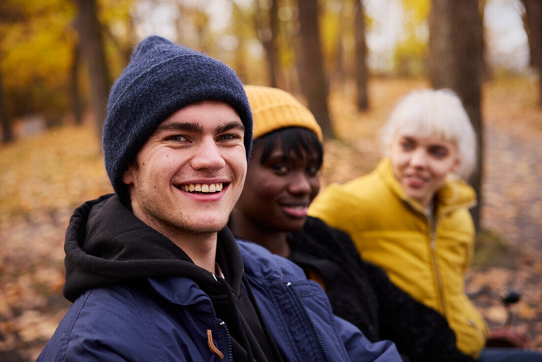 Three friends in park in autumn scenery