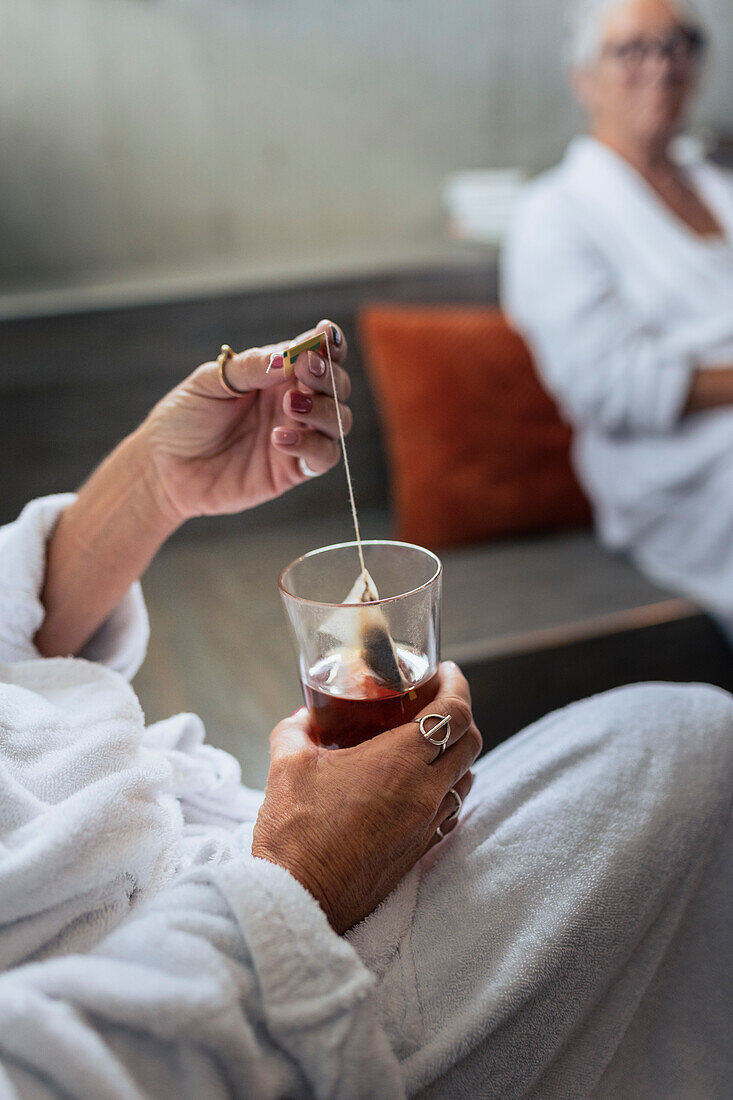 Woman's hand holding teabag