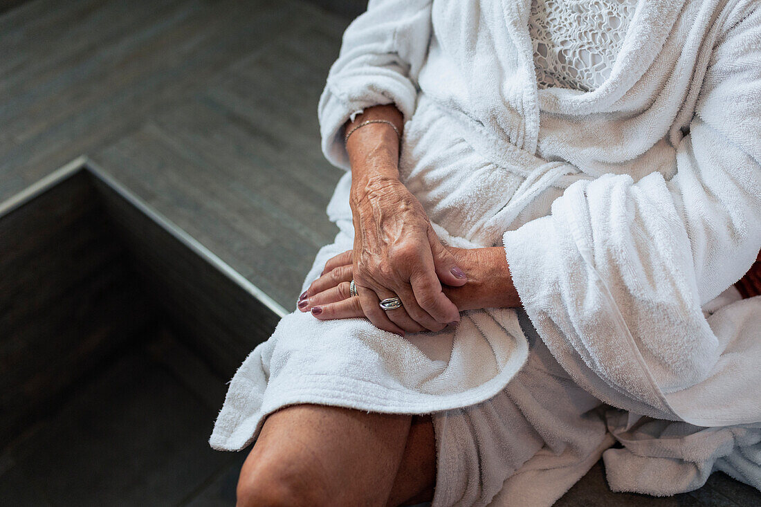 Mid section of senior woman sitting