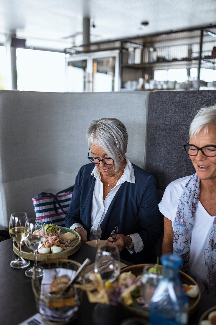 Senior women having meal in restaurant