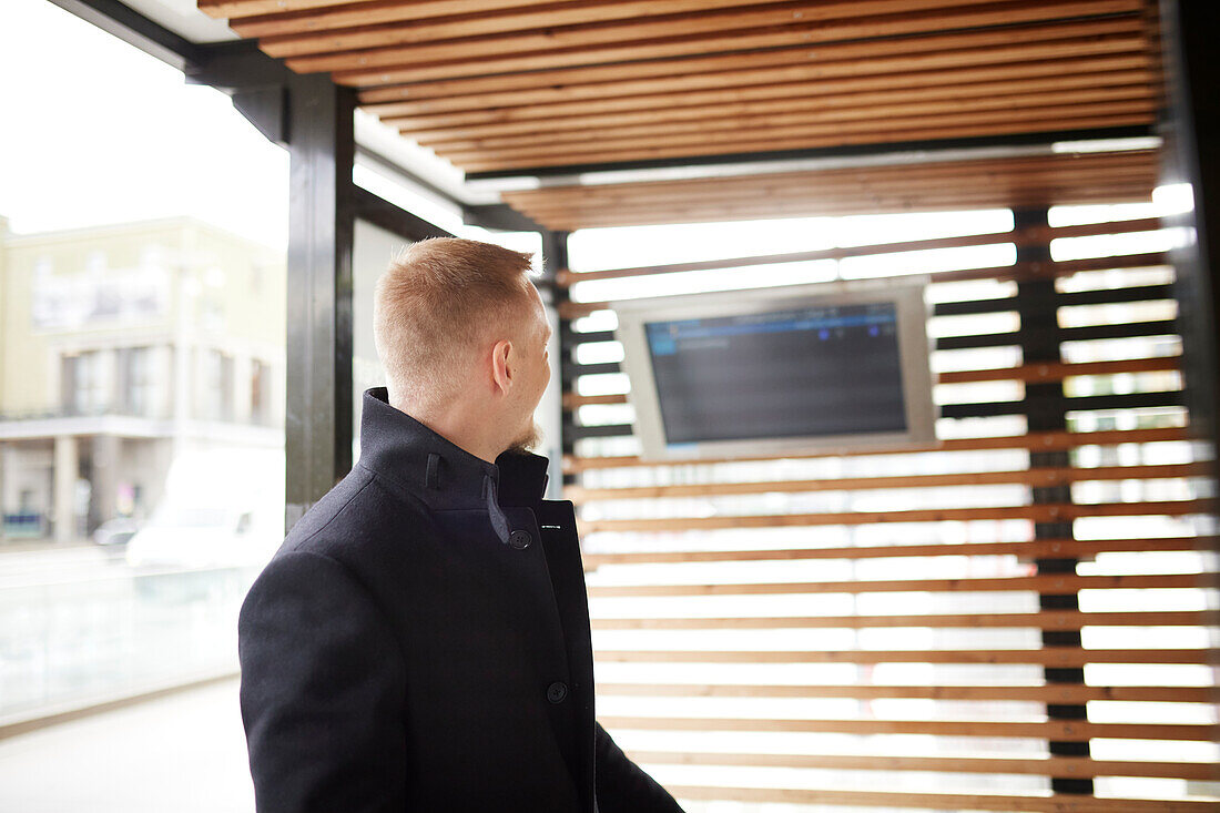 Man checking departure board