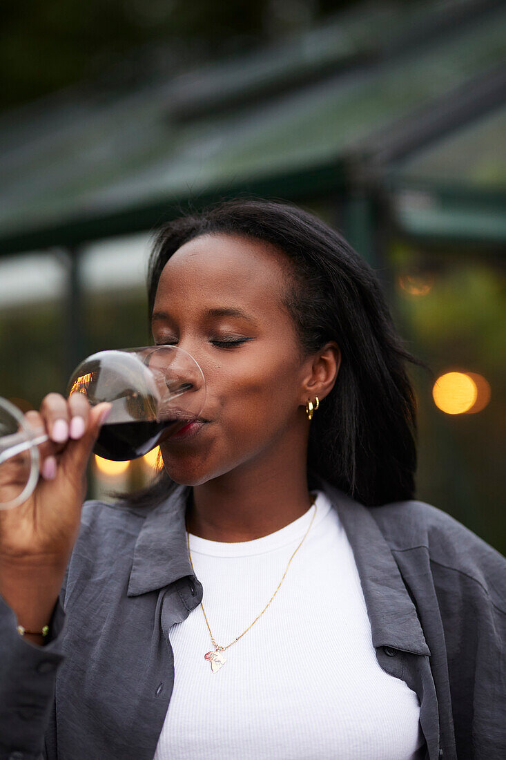 Smiling woman drinking wine