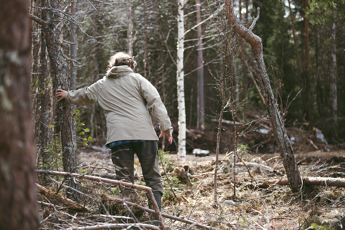 Woman walking in forest