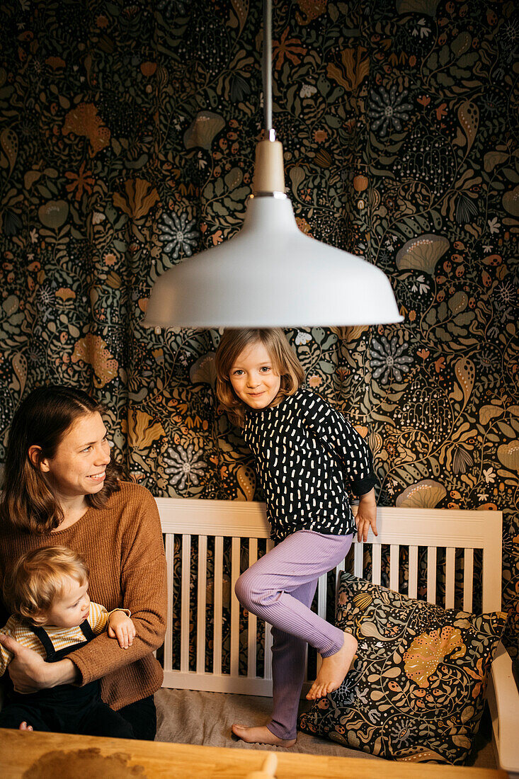 Mother with daughter and son at home