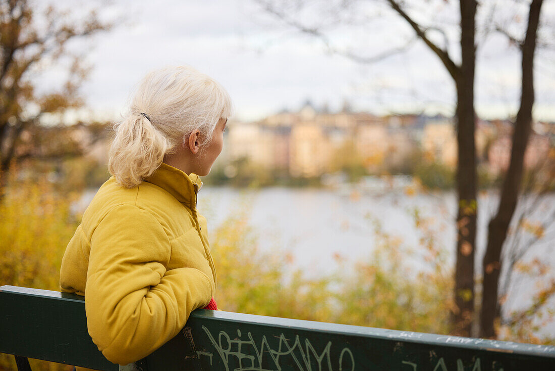 Young woman on bench looking away