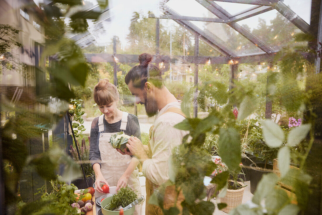 Smiling couple in greenhouse