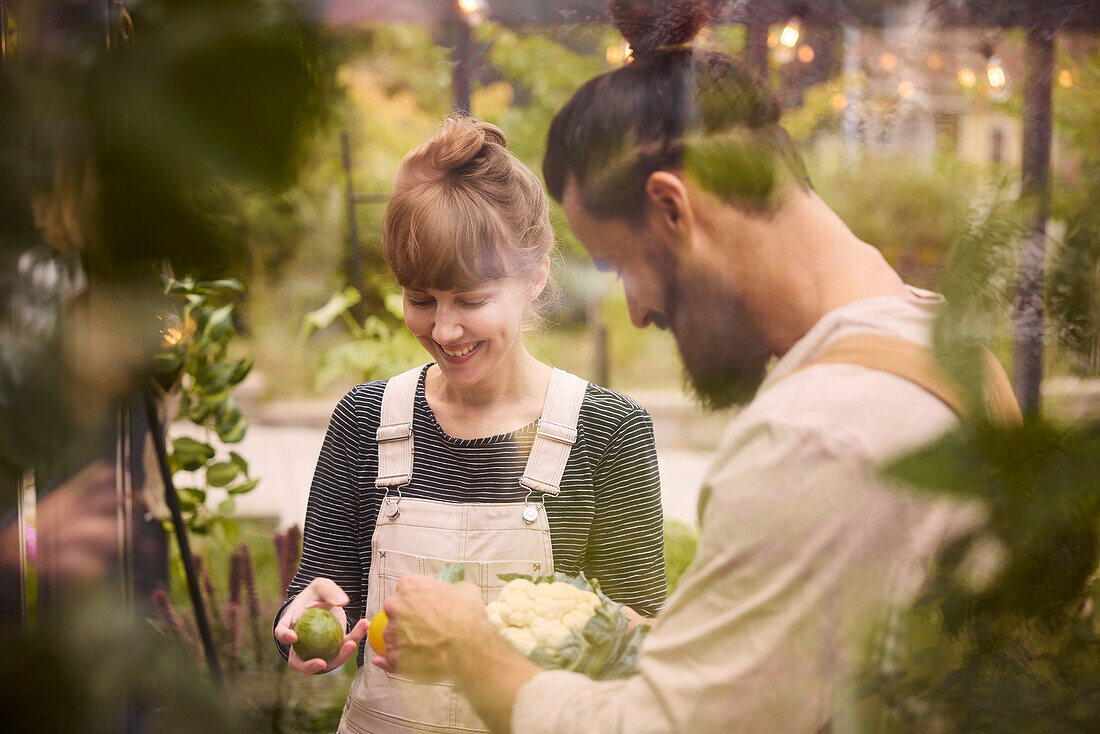 Smiling couple in greenhouse