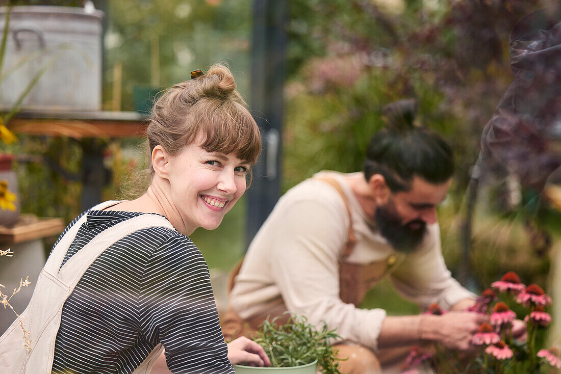 Smiling woman in greenhouse